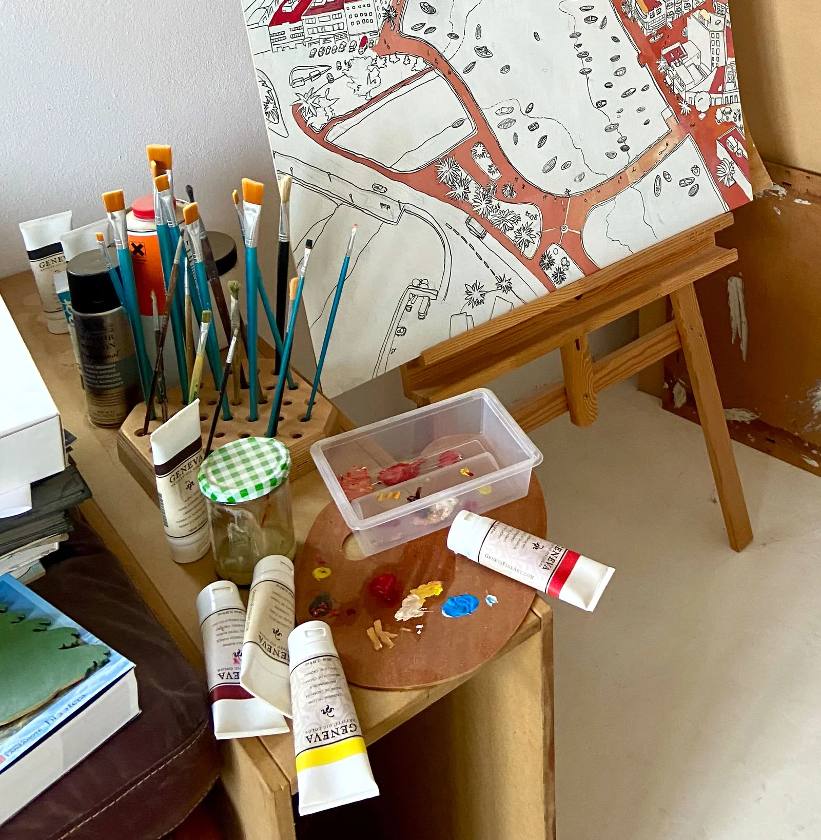 Brushes, paints and a drawing on an easel in Pekka's studio